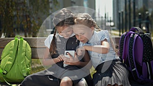 Girls Play With Smartphone At Schoolyard