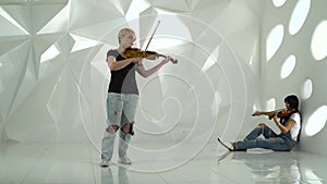 Girls play the violin lyric composition standing in a white room