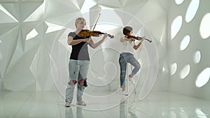 Girls play the violin lyric composition standing in a white room