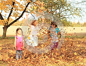 Girls playing barefoot with fallen leaves