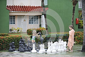 Girls playing big chess.
