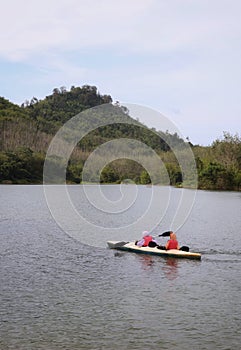 girls playing kayak in the lake