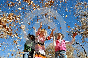 Girls playing with leaves