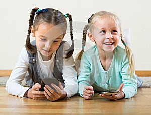 girls playing with smartphones