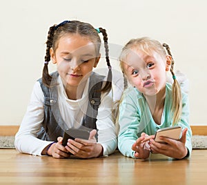 Girls playing with smartphones