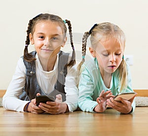 Girls playing with smartphones