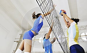 Girls playing volleyball indoor game