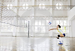 Girls playing volleyball indoor game