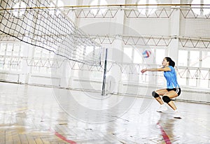 Girls playing volleyball indoor game