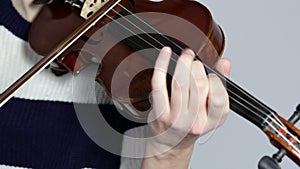 Girls plays the violin. Close-up of hands playing the violin. Woman, violin musician, playing.