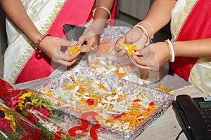 Girls prepare flowers for special ones in india stock photo