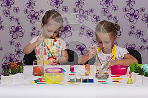 Girls are preparing for the Easter holiday, color eggs photo