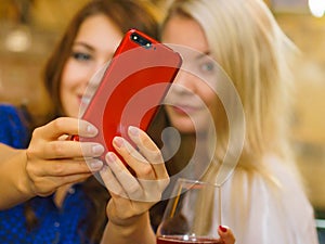Girls in pub club taking self photo with phone