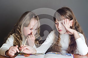 Girls read and one picks his nose