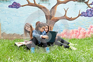 Girls reading a book in the park