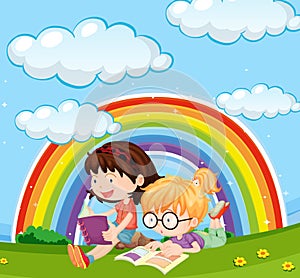 Girls reading book in park with rainbow in sky