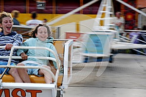 Girls on ride at fun fair