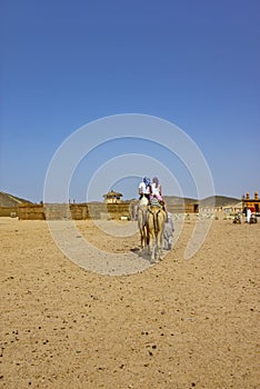 Girls riding camel, Egyptian desert