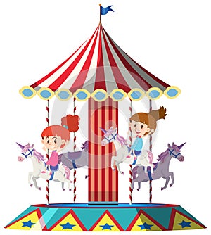 Girls riding on unicorn on merry go round