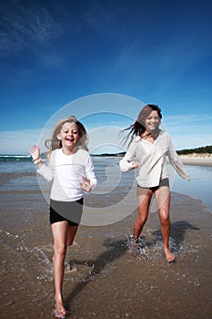 Girls running on beach