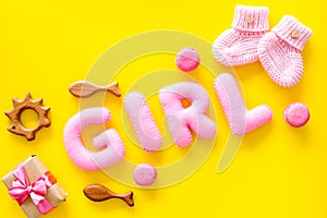 Girls`s birthday concept. Pink baby set with gift box on yellow backgound top view