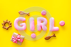 Girls`s birthday concept. Pink baby set with gift box on yellow backgound top view