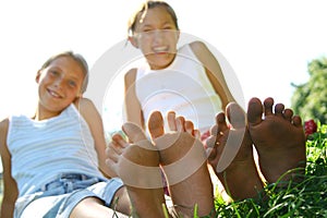 Girls sat on grass in summer