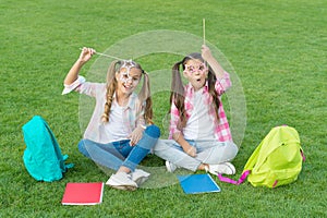 Girls school pupils doing homework together on fresh air, celebrate holiday concept