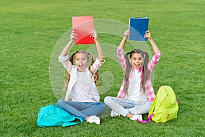 Girls school pupils doing homework together on fresh air, knowledge day concept