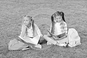 Girls school pupils doing homework together on fresh air, sad and tired concept