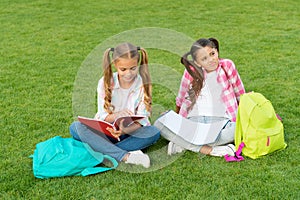 Girls school pupils doing homework together on fresh air, smart kids concept