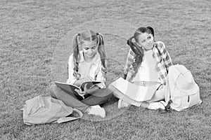 Girls school pupils doing homework together on fresh air, smart kids concept