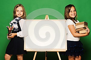 Girls in school uniform on green background