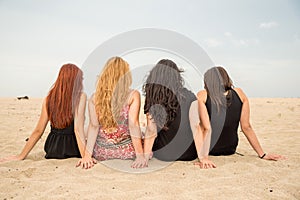 Girls seating on the beach