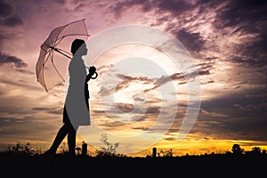 The girls silhouette style walking alone outdoor and umbrella in