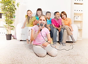 Girls singing in front of her friends