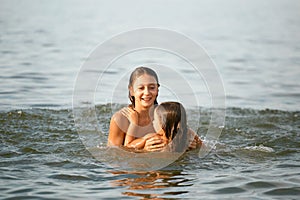 Girls sisters have fun bathing in the sea