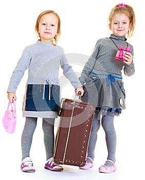 Girls sisters with an old suitcase