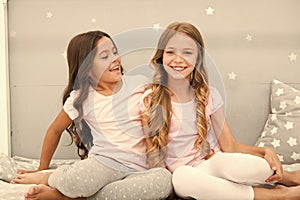 Girls sisters spend pleasant time communicate in bedroom. Sisters older or younger major factor in siblings having more