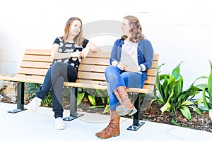 Girls Sitting on Bench together