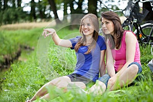 Girls sitting on a glade