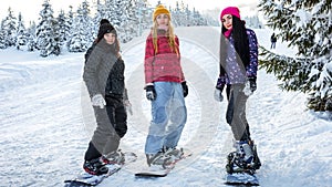 Girls snowboarders are on the boards at the ski slopes