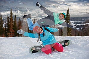 Girls snowboarders having fun and posing on the slope of a ski resort