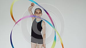 Girls in sport clothes rehearsing rhythmic gymnastics dance with ribbons