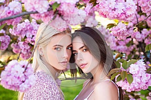 Girls in spring flowers. Fashion cosmetics and perfumes.