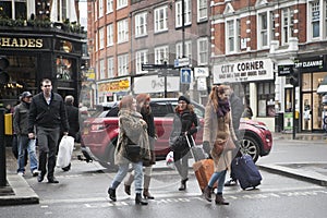 Girls with suitcases crossing the street near the National Express stop, where you can take a bus going to Stansted