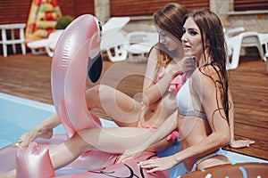 Girls on summer party in the swimming pool
