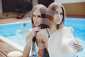 Girls on summer party in the swimming pool