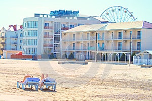 Girls sunbathe on sun loungers