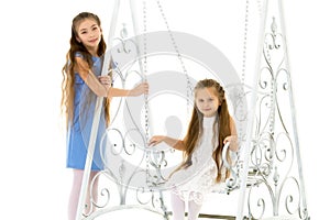 Girls swing on a swing.Isolated on white background.